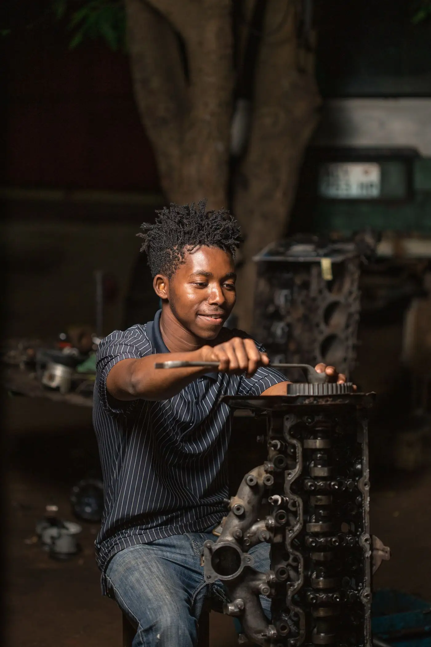 A qualified artisan stripping an engine