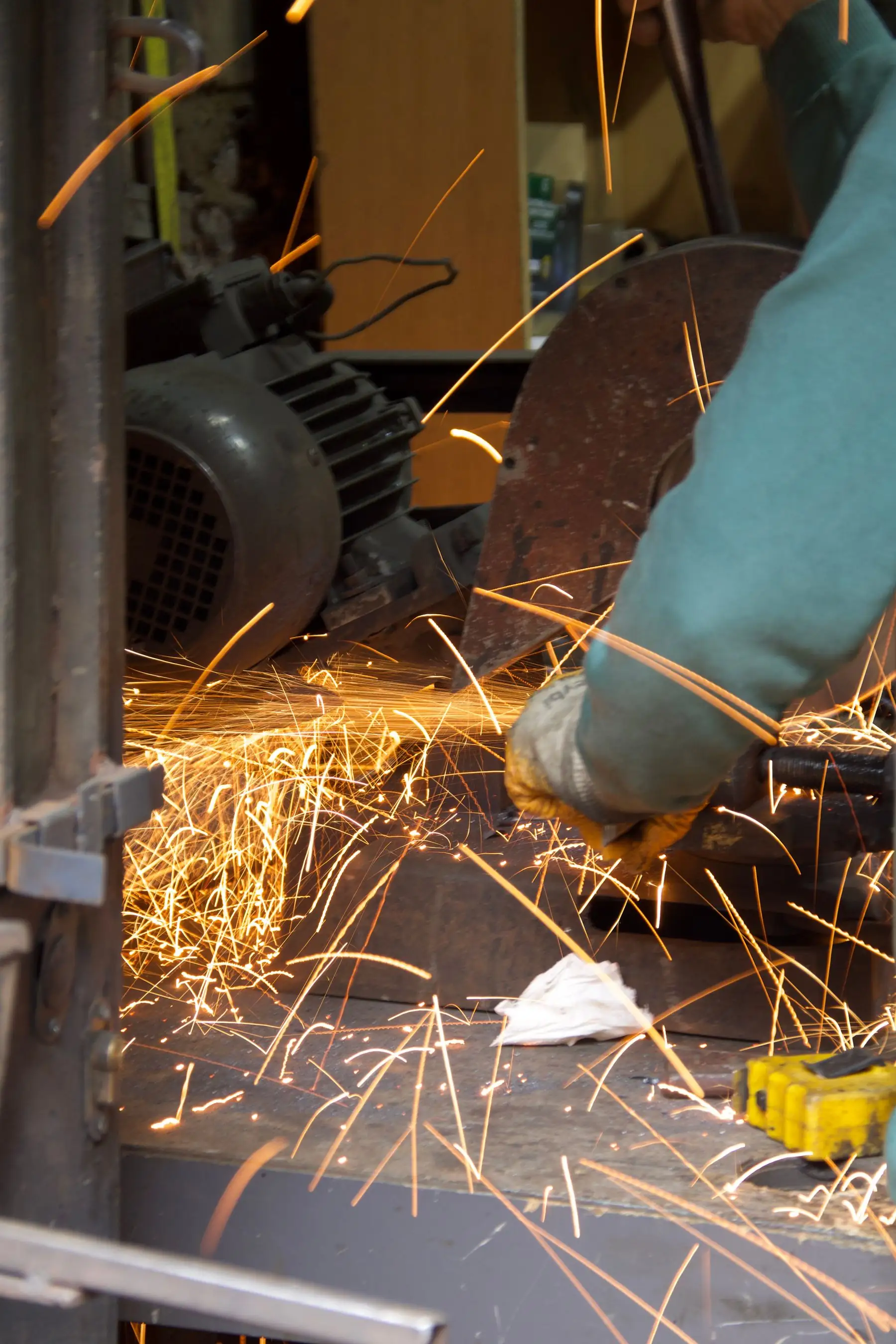 Sparks from an angle grinder in a fabrication shop