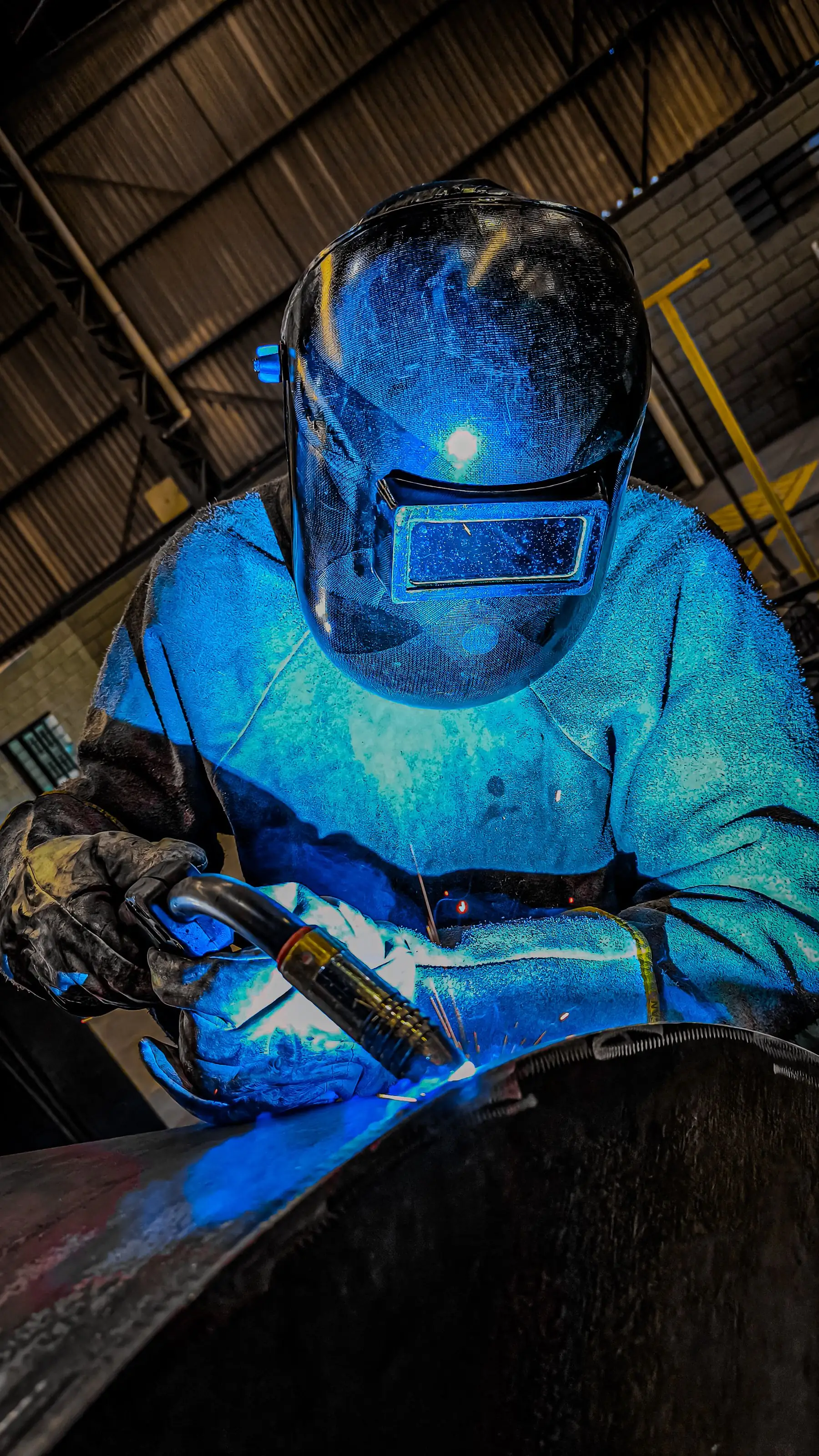 A welder in a shielding hood