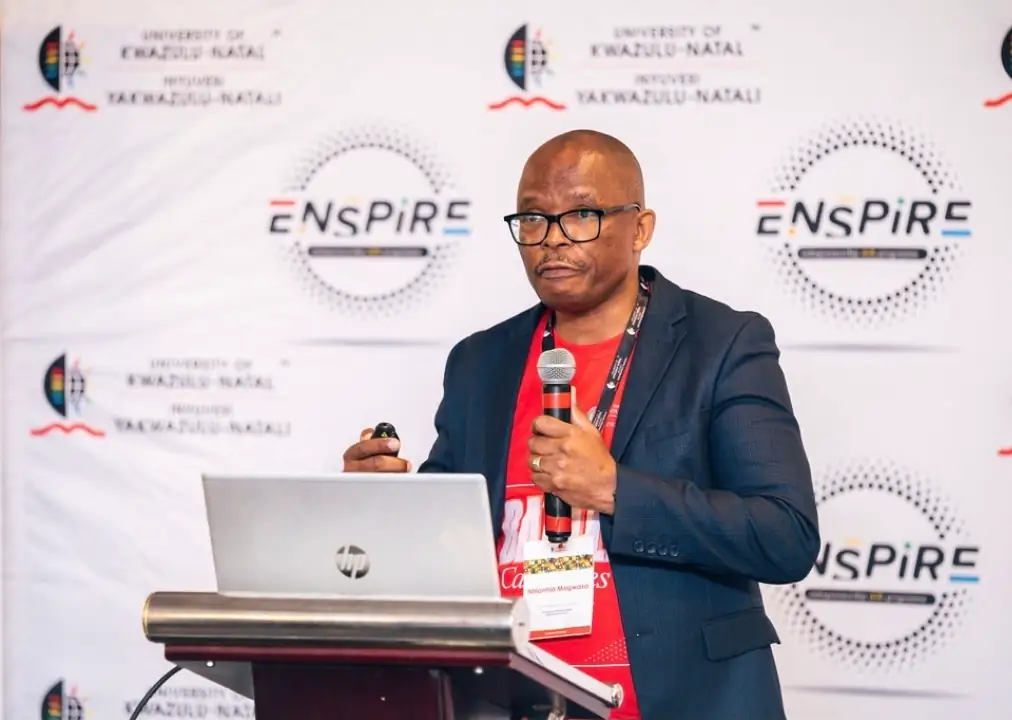 Nhlanhla Magwaza speaking at a podium